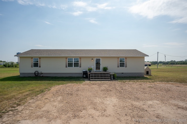 back of property featuring a lawn