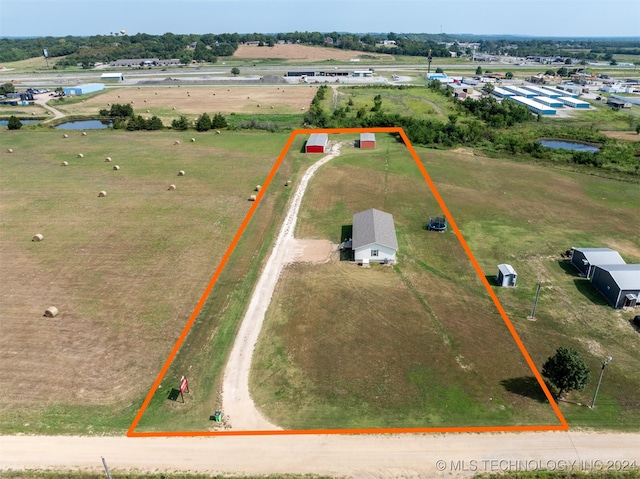 birds eye view of property featuring a water view and a rural view