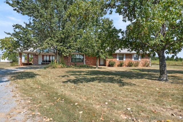 ranch-style home with a front lawn