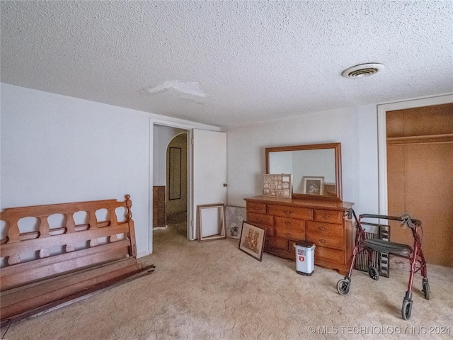 carpeted bedroom featuring a textured ceiling