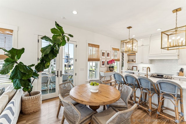 dining room featuring a notable chandelier and light hardwood / wood-style floors