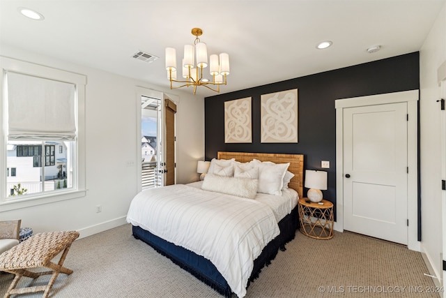 carpeted bedroom featuring an inviting chandelier