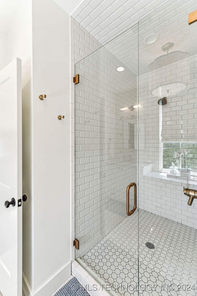 bathroom featuring tile patterned floors and a shower with door