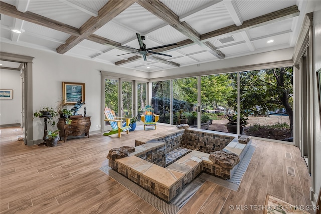 sunroom / solarium with beam ceiling, ceiling fan, and coffered ceiling