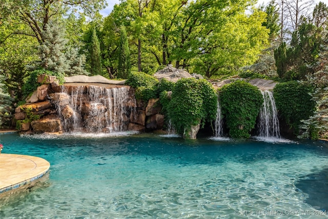 view of pool featuring pool water feature