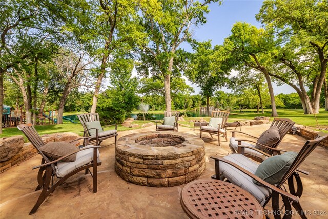 view of patio / terrace featuring a playground and a fire pit