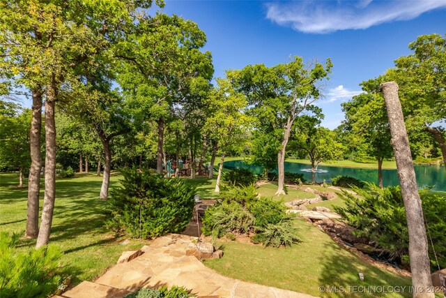 surrounding community featuring a yard and a water view