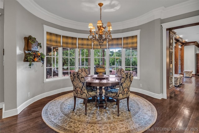 dining area featuring baseboards, a chandelier, crown molding, and wood finished floors