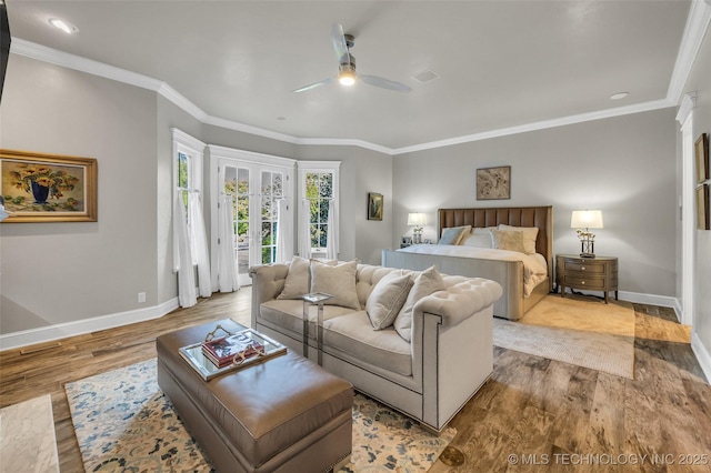 bedroom featuring access to outside, crown molding, baseboards, and wood finished floors