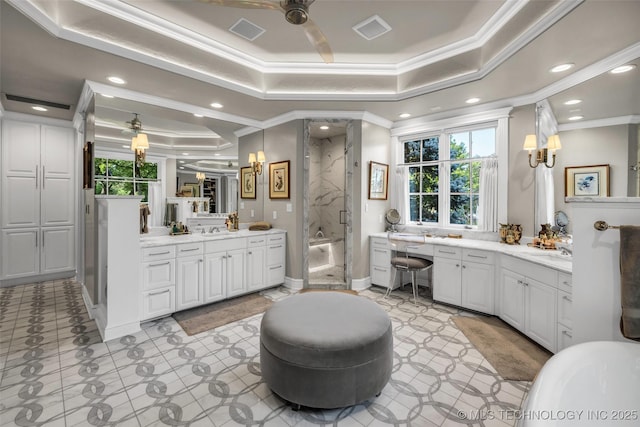 bathroom featuring a stall shower, a raised ceiling, visible vents, and plenty of natural light