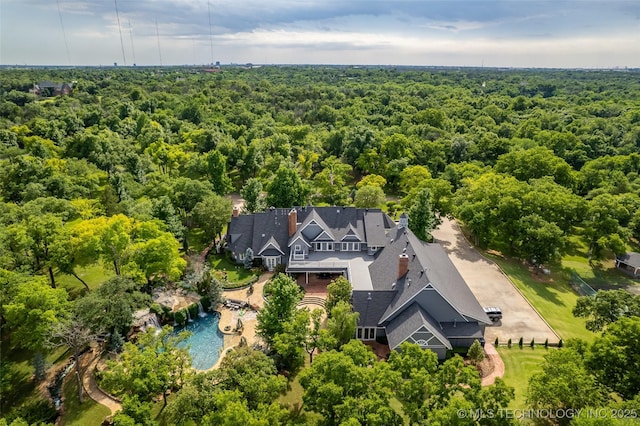 bird's eye view featuring a wooded view