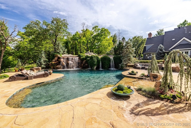 outdoor pool featuring an outdoor hangout area and a patio area