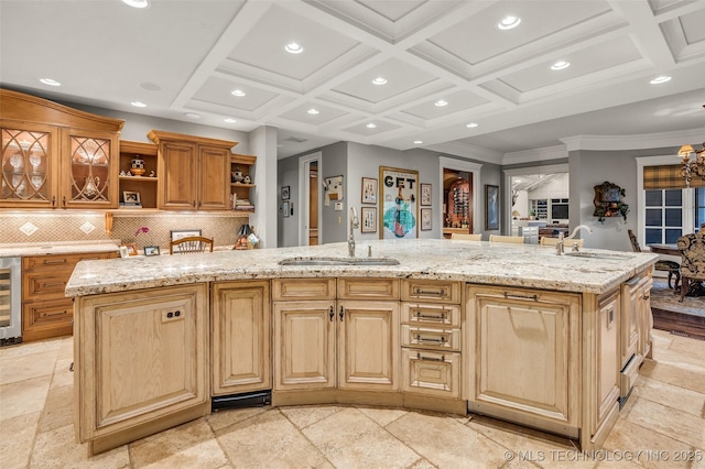 kitchen featuring beverage cooler, open shelves, coffered ceiling, and a sink