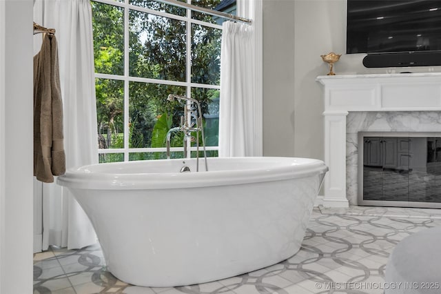 bathroom with vanity, a freestanding tub, and a high end fireplace