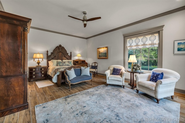 bedroom with crown molding, ceiling fan, wood finished floors, and baseboards