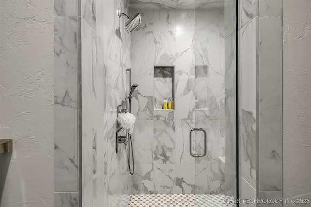 full bathroom with a textured wall and a marble finish shower