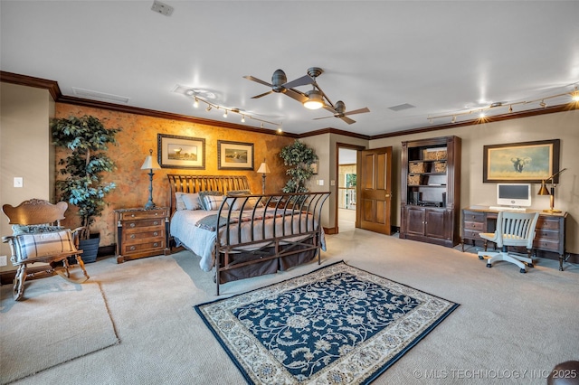 carpeted bedroom featuring rail lighting, visible vents, and ornamental molding