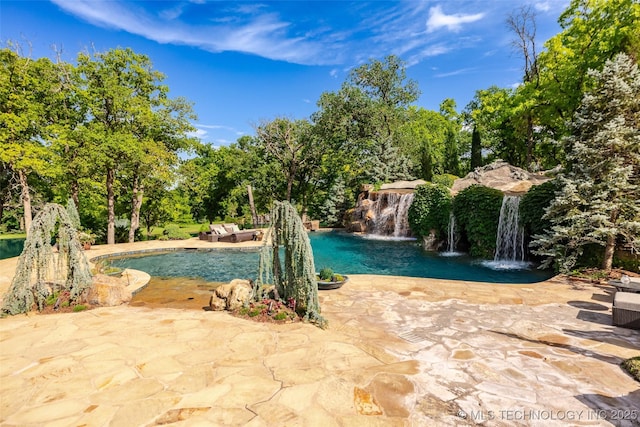 outdoor pool with a patio area