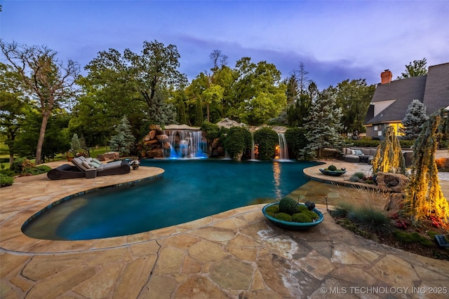 pool featuring a patio area and an outdoor living space