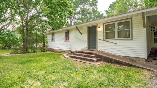 rear view of property with a yard