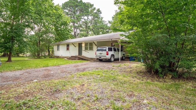 ranch-style house with a front yard and a carport