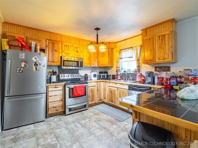 kitchen with sink, crown molding, and stainless steel appliances