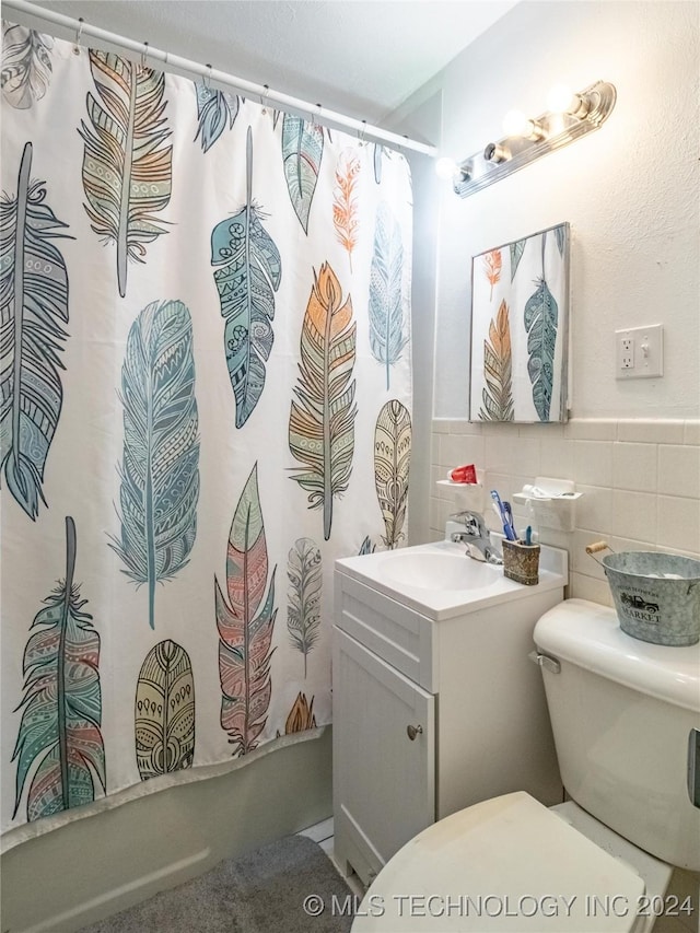 full bathroom featuring tile walls, vanity, shower / bath combo, and toilet