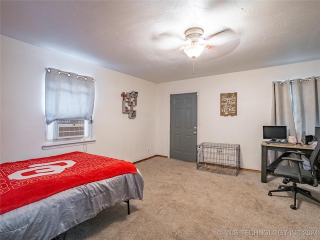 bedroom featuring cooling unit, light colored carpet, and a textured ceiling