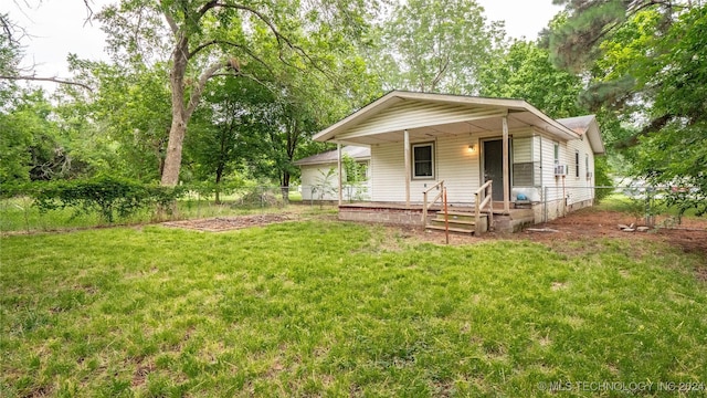 rear view of property featuring a yard