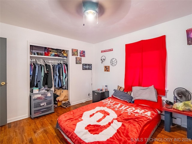 bedroom featuring hardwood / wood-style flooring, ceiling fan, and a closet