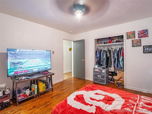 bedroom with hardwood / wood-style floors, a closet, and ceiling fan