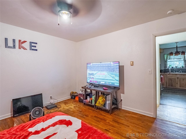 interior space featuring wood-type flooring and ceiling fan