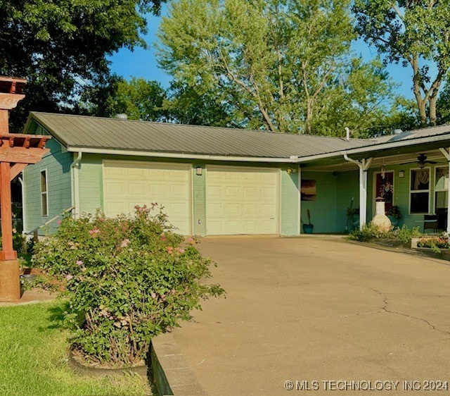 single story home with a pergola, a carport, and a garage