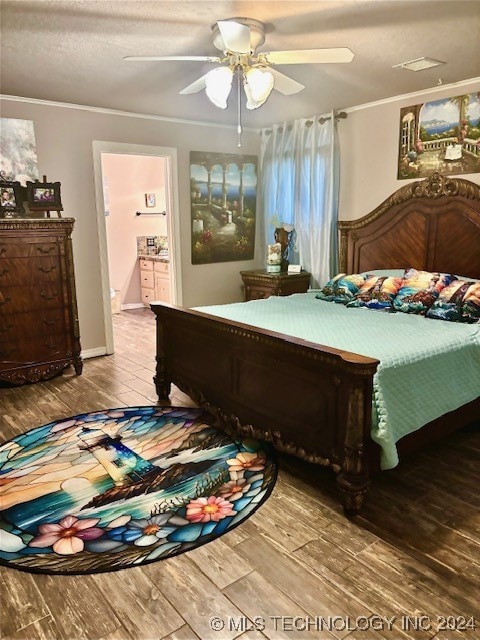 bedroom featuring connected bathroom, light hardwood / wood-style flooring, and ceiling fan