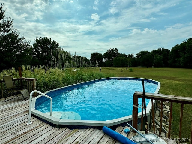 pool with a yard and a wooden deck