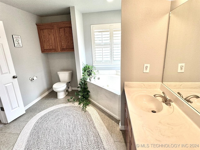 bathroom featuring tile patterned flooring, toilet, a garden tub, vanity, and baseboards