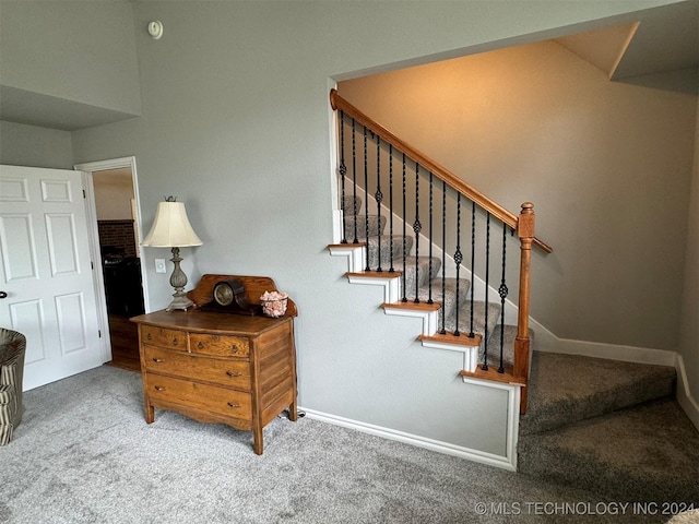 stairway with carpet and baseboards