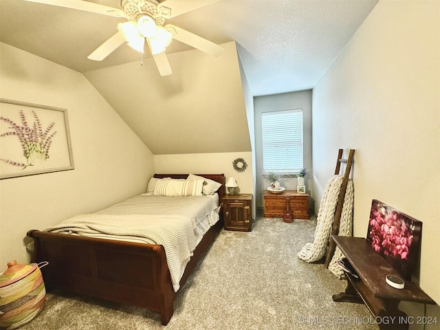 bedroom with light carpet, a textured ceiling, lofted ceiling, and a ceiling fan