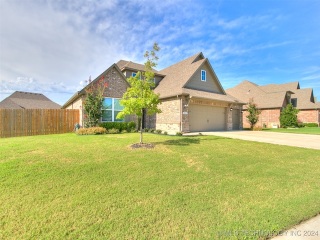 view of front of house featuring a garage and a front yard