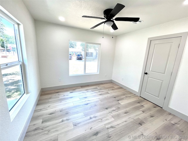 spare room featuring light wood-type flooring and ceiling fan