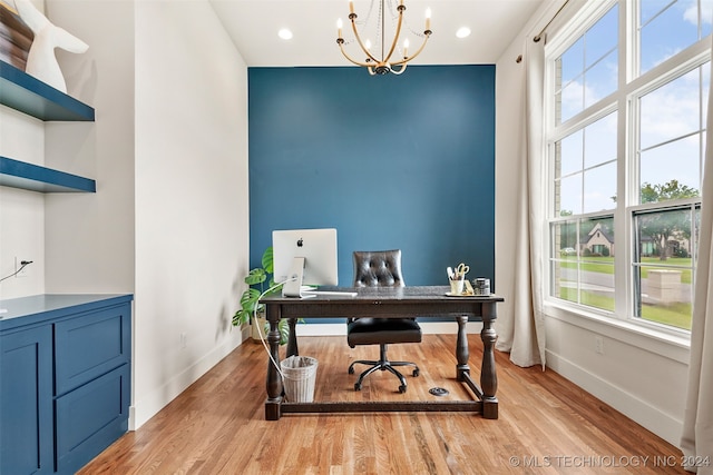 home office featuring an inviting chandelier and light hardwood / wood-style floors