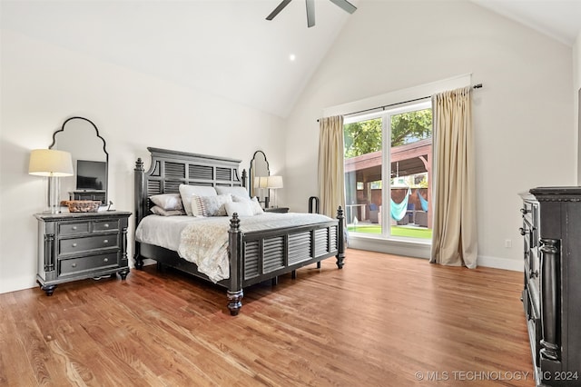 bedroom featuring ceiling fan, wood-type flooring, and high vaulted ceiling