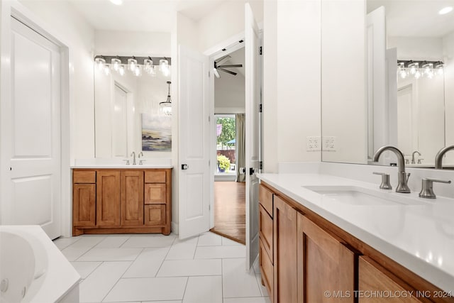 bathroom with ceiling fan, double sink vanity, a tub to relax in, and wood-type flooring