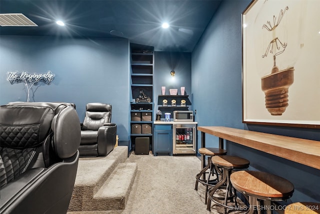 interior space featuring beverage cooler, bar, carpet, and built in features