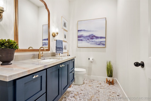 bathroom featuring vanity, tile patterned flooring, and toilet