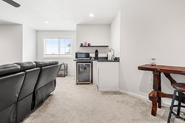 interior space with ceiling fan, wine cooler, and sink