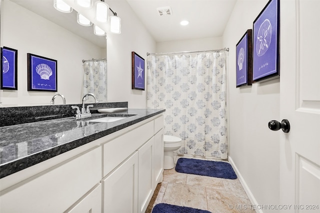 bathroom featuring tile patterned floors, vanity, and toilet