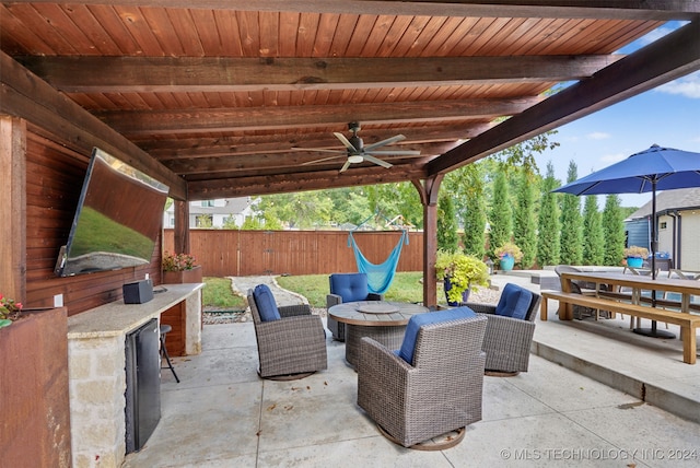 view of patio / terrace with ceiling fan and an outdoor living space