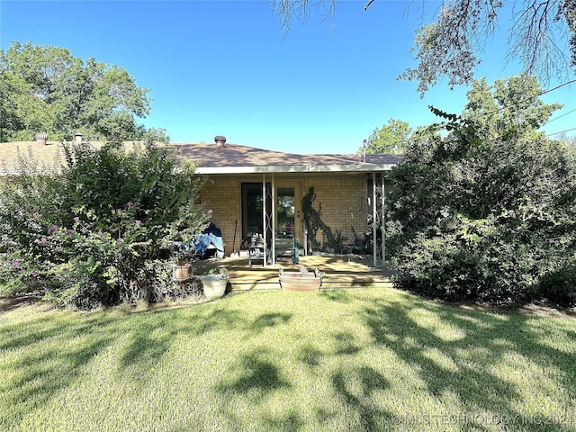 rear view of house with a lawn