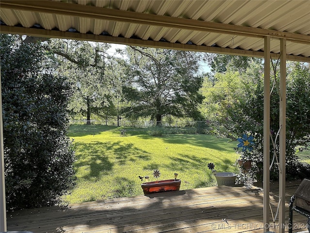 wooden terrace with a lawn